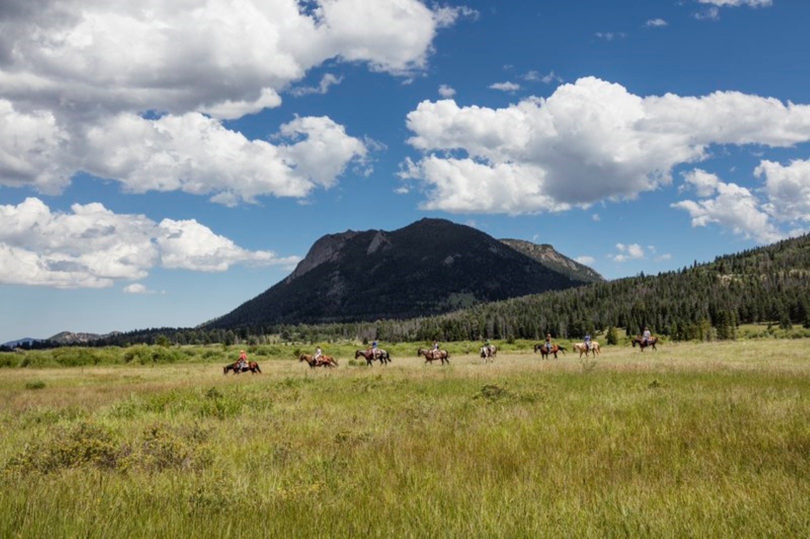 People riding horses in Rocky Mountain National Park.