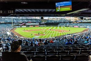 People watching baseball game sin Seattle, WA, USA. Asia is dominating summer travel trends.