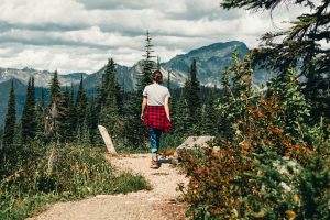 A woman taking nature walk in Mount Revelstoke, Columbia-Shuswap B, BC, Canada. Digital detox retreats.