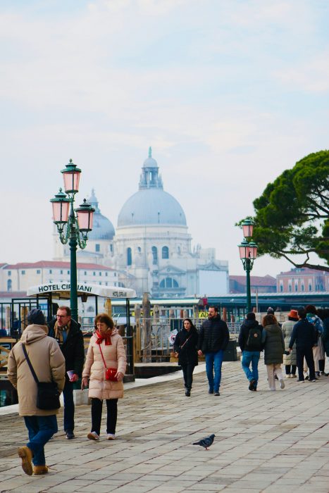 Tourists walking on a street in Venice, Italy.